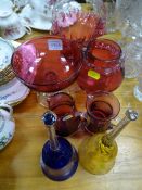 Collection of cranberry glassware and two coloured glass bells