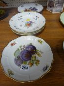Three floral and insect decorated plates with blue cross sword marks and two Rosenthal fruit