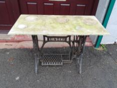 Vintage Singer treadle sewing machine base with marble top