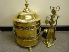 Brass lidded coal bin with lion mask handles and a fireside companion set