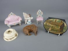 Bretby plaque of Ann Hathaway's cottage, an early porcelain model of a recumbent bear, a vintage