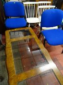 Coffee table with three glass bevelled edge inserts, three white painted stickback chairs and a pair