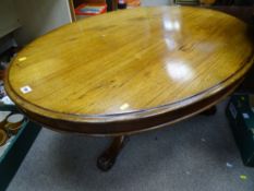 Large oval coffee table on scrolled tripod base