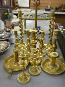 Collection of antique and other brass candlesticks including an open twist pair and a brass kettle