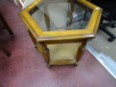 Modern rectangular occasional table with glass top and cane lower shelf and a modern black office