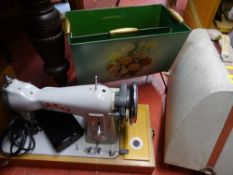 Cased Jones sewing machine and a vintage metal magazine rack E/T