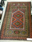 Old Baluchi prayer rug, multi-bordered deep colours with central red and blue ground panel, 148 x 88