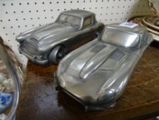 Two metallic car models, one Jaguar E-Type and MG