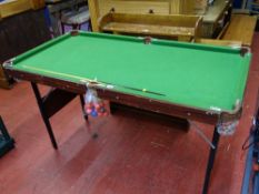 Small snooker table with balls and cues, approx 140 x 75 cms overall