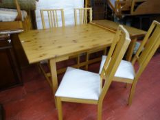 Ikea pine dining table with two extra leaves and four chairs