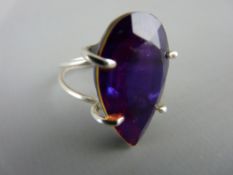 Modern silver ring set with a large facet cut quartz type stone