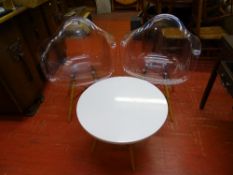Pair of Eiffel style transparent chairs and a matching white topped occasional table