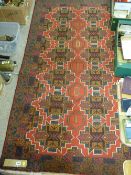 Old Baluchi rug, bold red central pattern on a deep blue ground, 197 x 108 cms