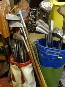 Two golf bags and clubs some with hickory shafts