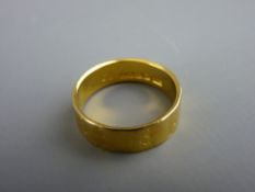 Twenty two carat gold wide wedding band with leaf decoration, 4.5 grms