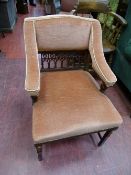 Pink upholstered armchair with pierced detail to back