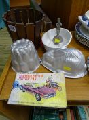 Pottery jelly mould, two tin jelly moulds, small wooden planter, small metallic presentation