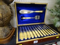 Excellent canteen of twelve bone handled fish knives and forks with matching pair of servers in silk