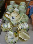 Tuscan china part coffee set and a green and gilt Paragon Fine China daffodil decorated part teaset