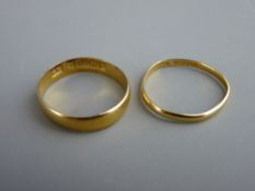 Twenty two carat gold wide wedding band and a very narrow twenty two carat gold band, 3.6 grms