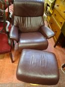 Burgundy faux leather upholstered Restless easy chair and footstool