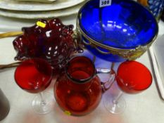 Bristol blue bowl on a brass stand with lion mask handles, a ruby glass bowl and a cranberry jug and