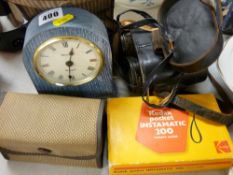 Cased pair of Hezzanith racing binoculars, modern mantel clock and three vintage cameras