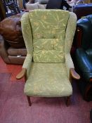 Light coloured floral upholstered easy chair with wooden arms