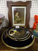 Four black and gilt Grecian novelty plates and a framed print of 'Bubbles'