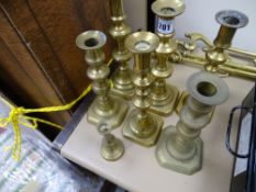 Two pairs of square based brass candleholders, two odd ones and a miniature circular based