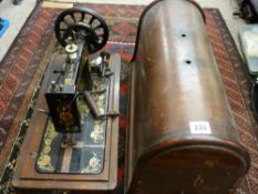 Old wooden cased hand driven Singer sewing machine