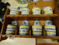 Wooden spice rack with eight pottery spice containers and lids