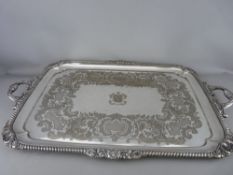 A LARGE RECTANGULAR TWIN HANDLED SERVING TRAY by Elkington & Co having a mask and shell rope twist