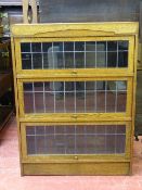 AN OAK WERNICKE STYLE SINGLE PIECE BOOKCASE with leaded glazed lift-up front doors, 114.5 cms