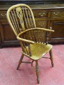 A WELL COLOURED WINDSOR ELBOW CHAIR, elm seated and yew backed spindle and splat chair with