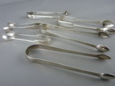 A PARCEL OF SIX (FOUR GEORGIAN) SILVER SUGAR TONGS, total 6 troy ozs