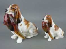 TWO ROYAL DOULTON SEATED SPANIELS with pheasants in their mouths, HN1028 and HN1029, 13 and 9 cms