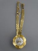 A NINE CARAT GOLD ROTARY LADY'S WRISTWATCH on bracelet strap with safety chain, 15.4 grms gross