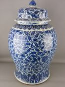 A LARGE CHINESE BLUE & WHITE TEMPLE JAR & COVER, with all over painted leaf and floral design, the