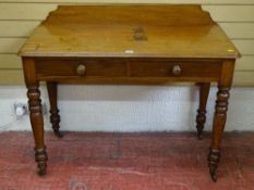 A VICTORIAN MAHOGANY TWO DRAWER SIDE TABLE with shaped railback on turned supports and brass