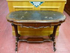 A VICTORIAN SHAPED TOP AND CARVED MAHOGANY SINGLE DRAWER WRITING TABLE with shelf cross rail on