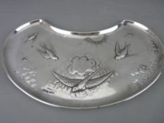 A KIDNEY SHAPED TRAY with an embossed pattern of a sunburst and birds flying amongst clouds,