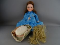 AN ARMAND MARSEILLE BISQUE HEADED DOLL with two wigs, numbered 390A3M, open mouth with four teeth