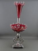 AN EPBM & CRANBERRY GLASS TABLE EPERGNE with griffin and scroll mounts, 65 cms high overall