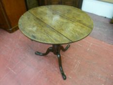 AN ANTIQUE OAK TRIPOD TABLE with 74.5 cms diameter circular top, 68 cms high