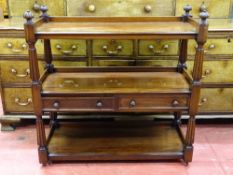 A REGENCY MAHOGANY THREE TIER DUMB WAITER with twin central drawers and carved reeded detail and