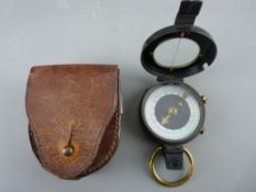 A LEATHER ENCASED MILITARY-STYLE BLACK METAL & BRASS POCKET COMPASS (no maker's mark visible)
