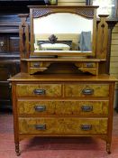 A CIRCA 1900 WALNUT MIRRORED DRESSING CHEST having two upper drawers with shelf over two short and
