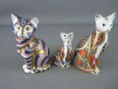 THREE ROYAL CROWN DERBY CAT PAPERWEIGHTS, numeral backstamps MMI and LXII, both gold stoppers and