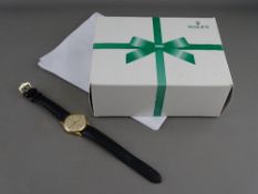 A GENT'S NINE CARAT GOLD ROLEX PRECISION WRISTWATCH on Hirsch leather strap, champagne dial with